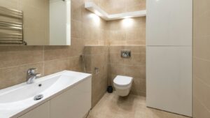 Elegant small bathroom interior with modern fixtures, neutral tones, and ample lighting showcasing smart floor tile layout.