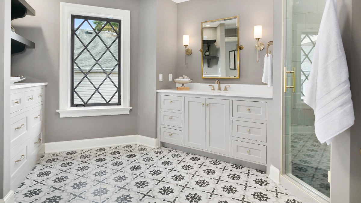 A bathroom featuring grey and white patterned floor tiles